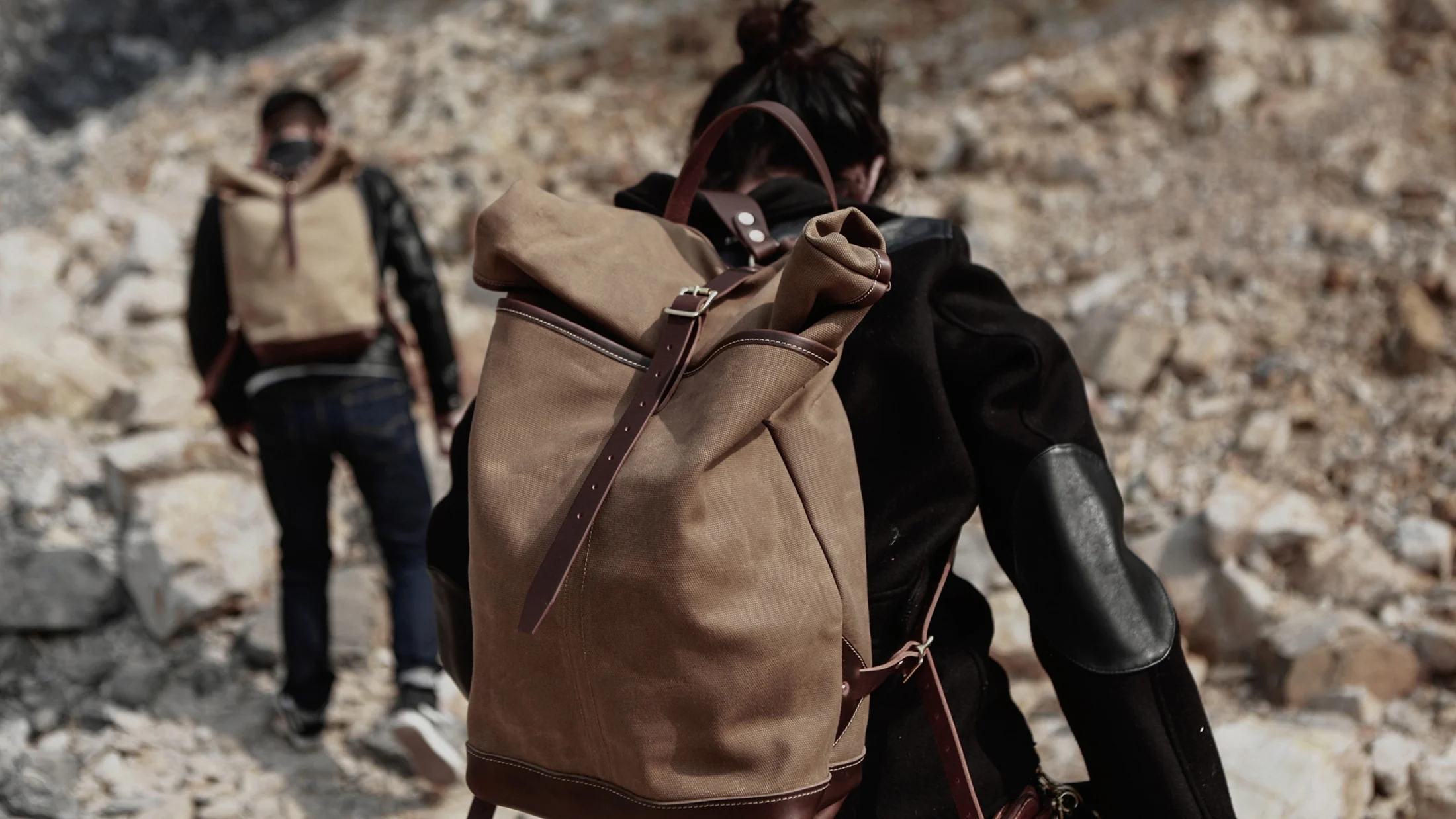 A handmade canvas and leather backpack carried outdoors